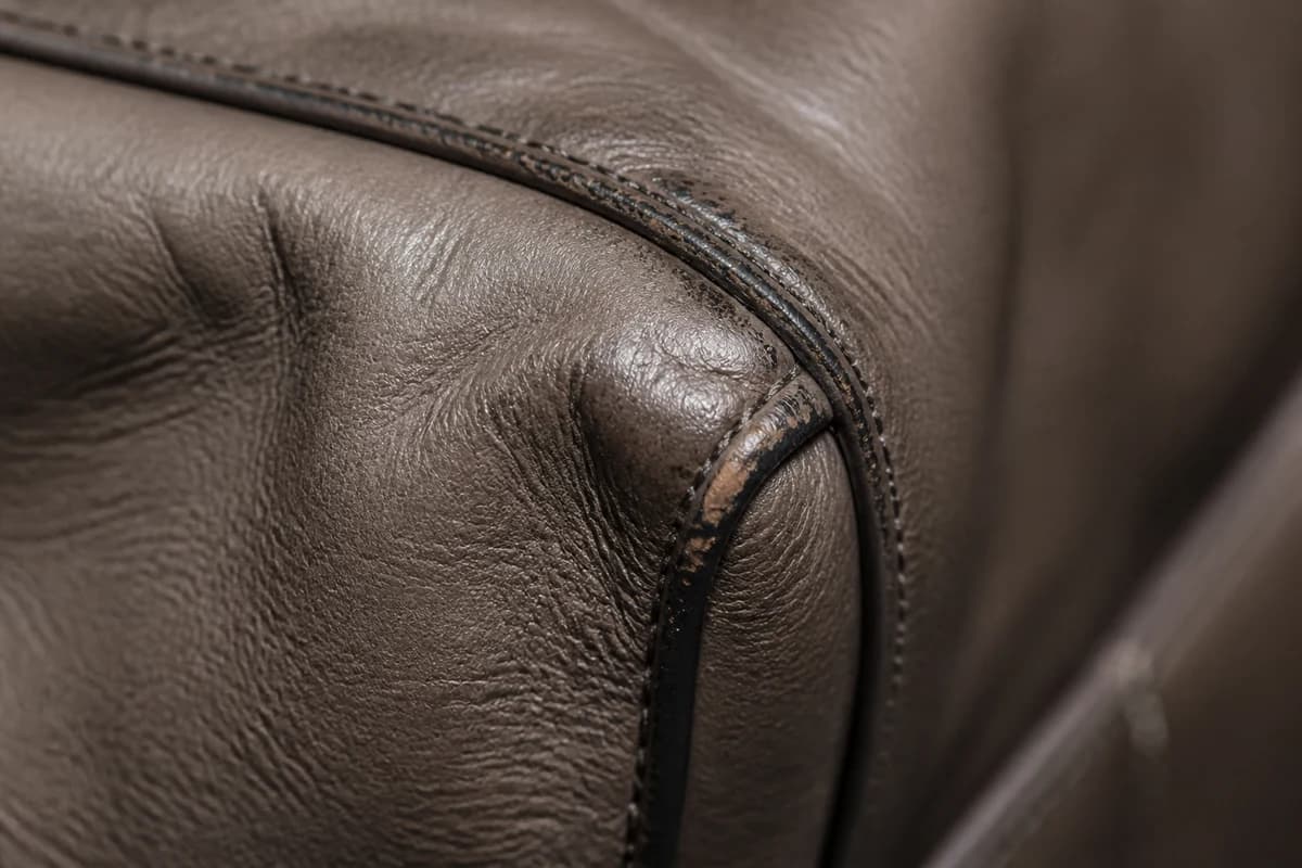 Close-up of collapsed bag corner and failed edge paint showing when restoration is needed