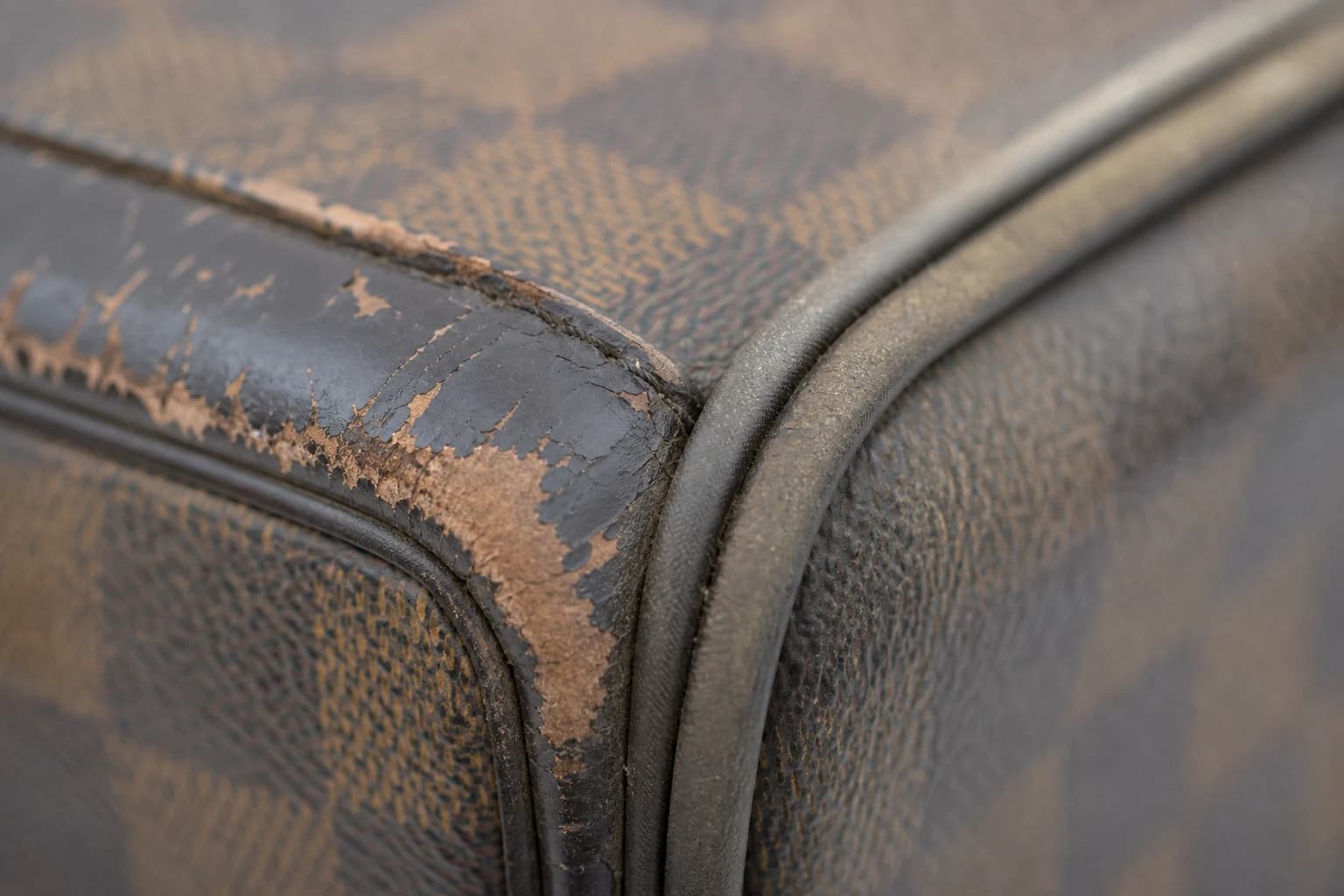 Worn bag corner and edge paint showing why luxury bag restoration Dubai differs from cleaning