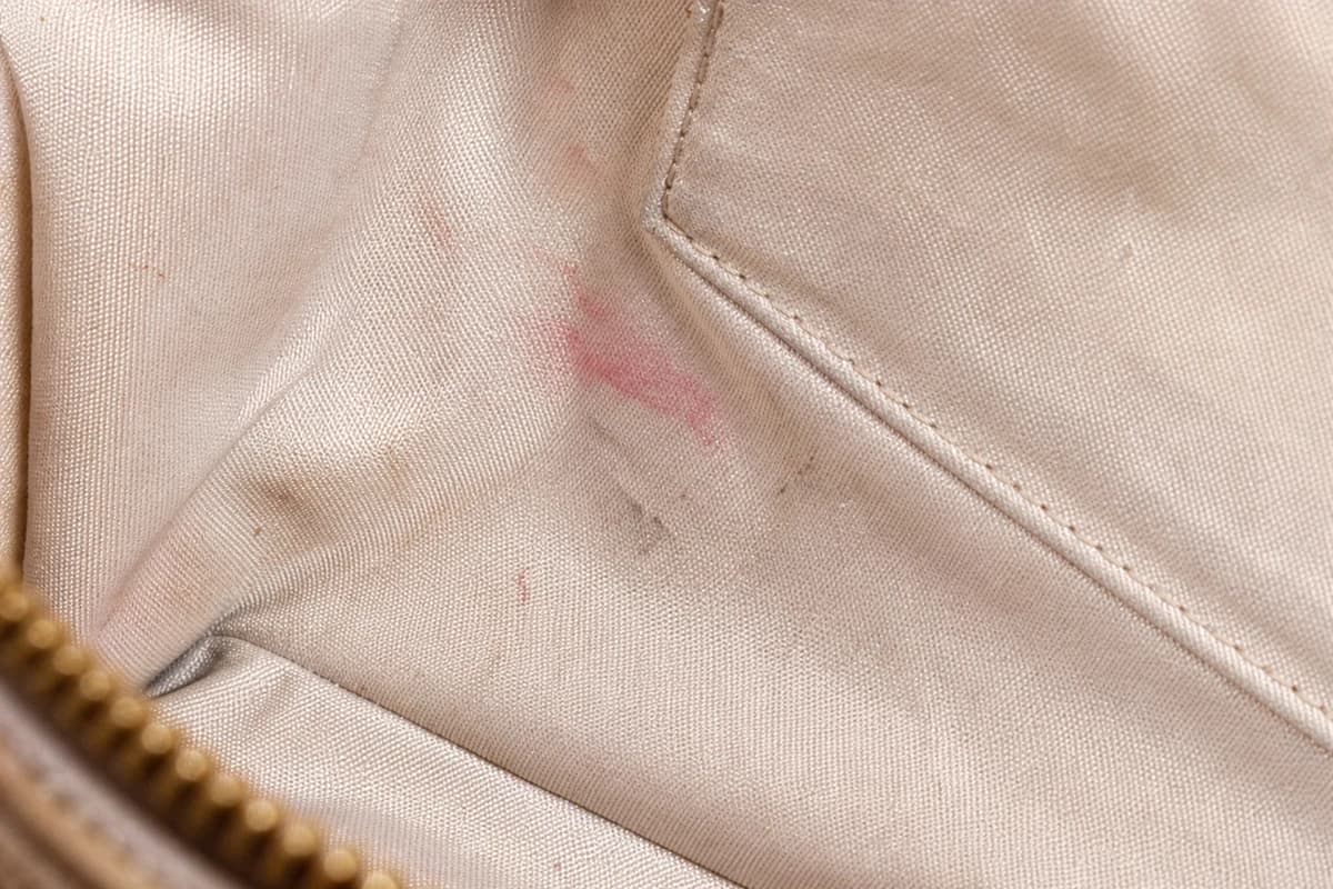 Close-up of fabric handbag lining marks before interior cleaning in Dubai