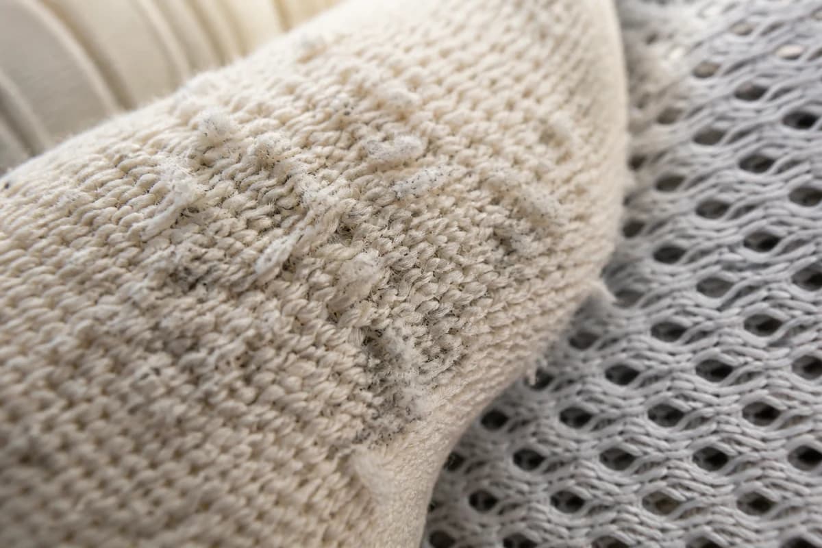 Macro of pilled knit yarn loops and scuff marks before knit shoe cleaning Dubai