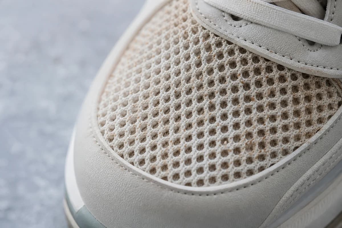 Macro of athletic mesh cells holding Dubai dust during sneaker stain removal Dubai assessment