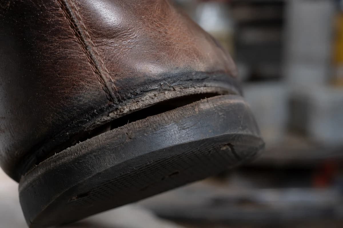 Close-up of worn sole edge showing why shoe restoration Dubai may change a cleaning quote