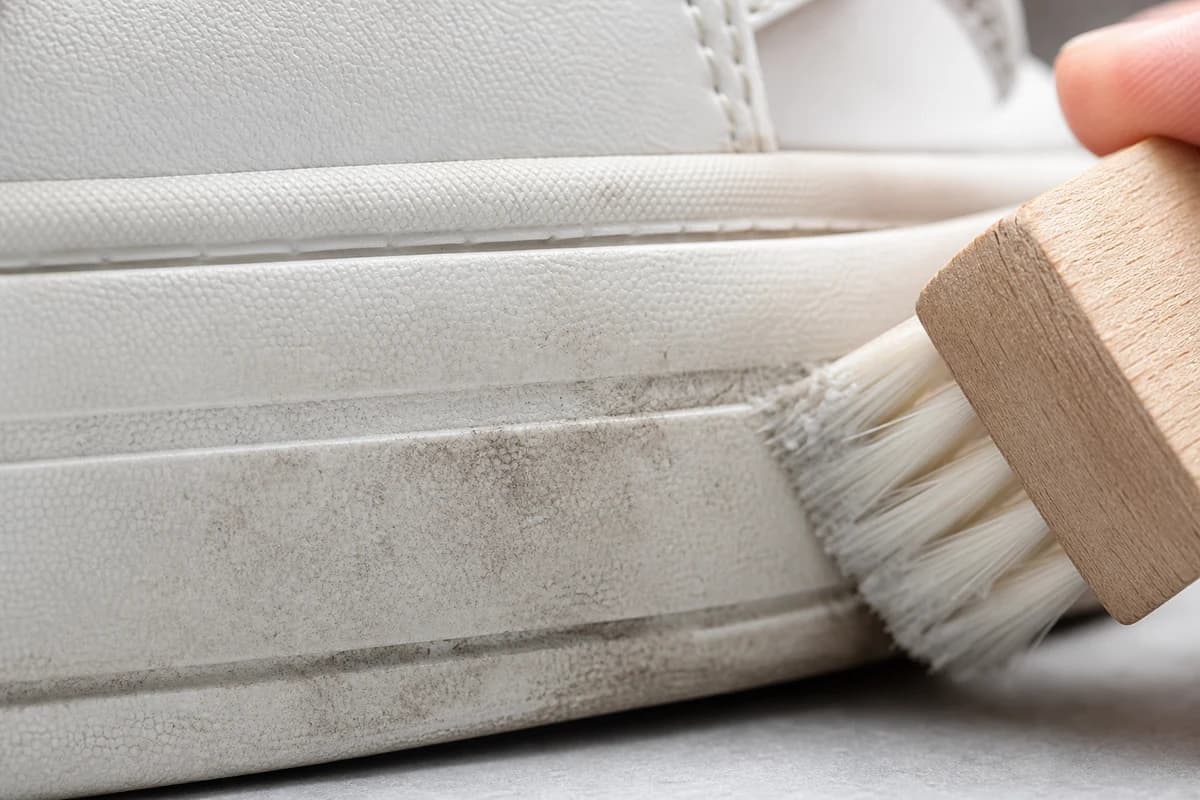 Macro detail of sneaker stain removal Dubai on a white midsole sidewall